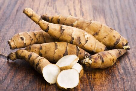 Raw Whole Jerusalem artichokes on a wooden backgroundの写真素材