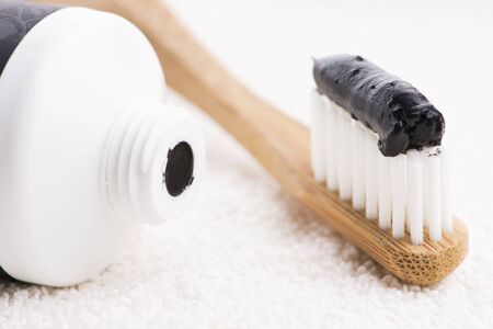 Toothbrush with black charcoal toothpaste