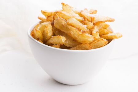 Bowl of potatoe fries on a white backgroundの写真素材