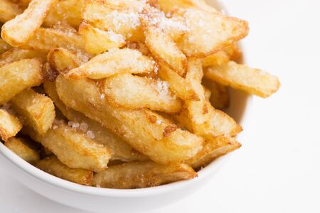 Bowl of potatoe fries on a white background