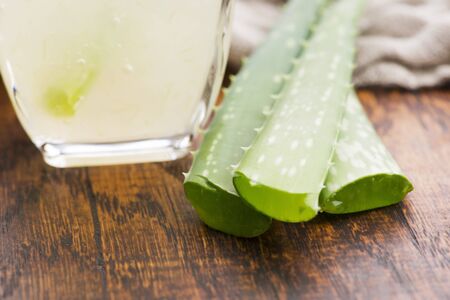 Glassware with fresh aloe vera juice and leavesの写真素材