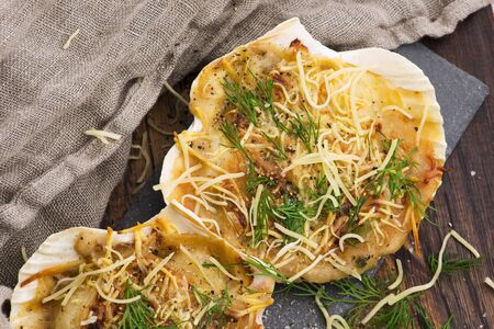 Baked scallops with cheese and spicy sauce.の写真素材