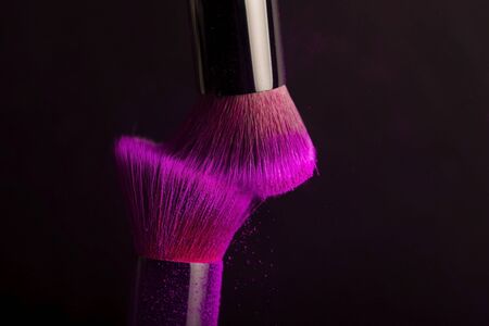 Cosmetics brush and colorful makeup powder