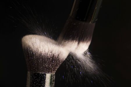 Cosmetics brush and colorful makeup powderの写真素材