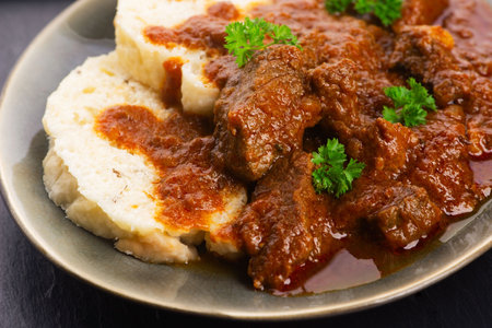 Beef goulash and dumplings (knedliky) on tableの写真素材