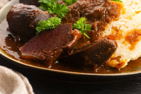 Stewed goose stomach.  Traditional Polish meat on a dark background.の写真素材