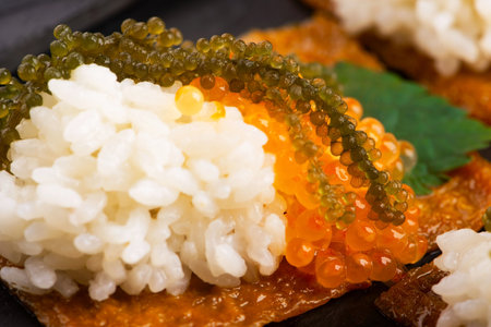 Inari sushi with caviar, rice, shiso and umibudoの写真素材