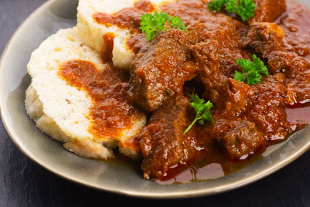 Beef goulash and dumplings (knedliky) on tableの写真素材