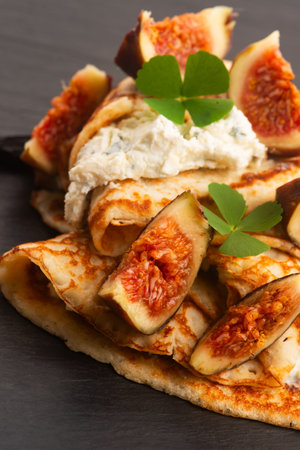 Crepes or thin pancakes with gorgonzola cheese, honey and figs fruits
