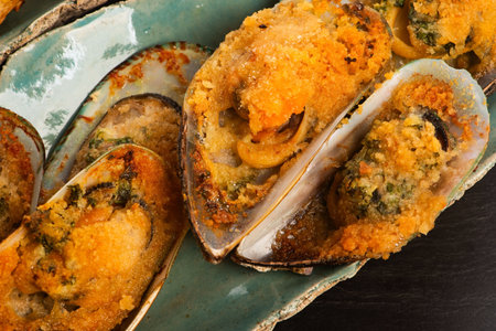 Baked New Zealand Mussels with Garlic Butter and Breadcrumbs on Handmade Ceramic Plate