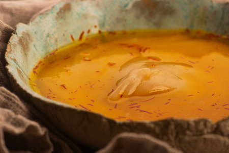 Traditional Polish Sour Rye Soup with Saffron in Ceramic Bowl