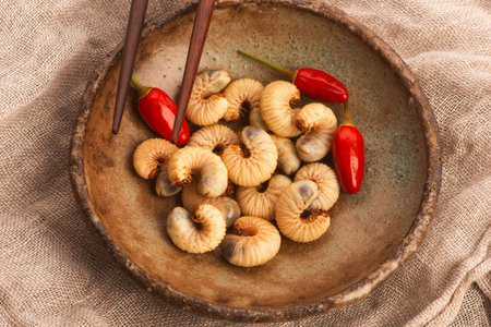Dried figs with chili peppers on plate, closeupの写真素材