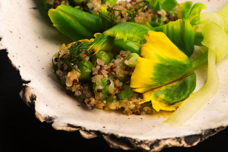 Stuffed Green Parrot Tulips with Quinoa, Peas and Honey on Handmade Ceramic Plateの写真素材