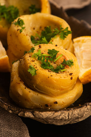 Delicious artichoke hearts beautifully seasoned and served in a rustic bowl for a healthy mealの写真素材
