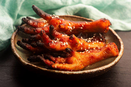 Spicy Korean Chicken Feet (Dakbal) in Handmade Ceramic Bowlの写真素材