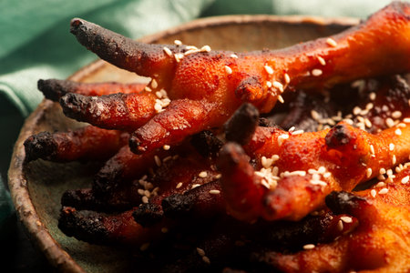 Spicy Korean Chicken Feet (Dakbal) in Handmade Ceramic Bowlの写真素材