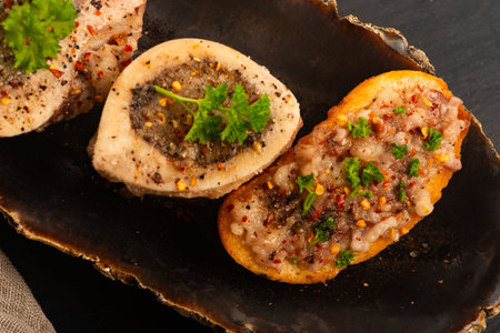 Roasted Bone Marrow with Spices and Baguette in Handmade Ceramic Bowlの写真素材