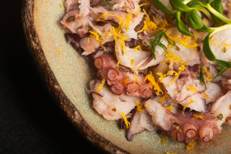 Octopus Carpaccio with Lemon in Handmade Ceramic Bowlの写真素材