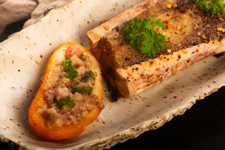 Roasted Bone Marrow with Spices and Baguette in Handmade Ceramic Bowlの写真素材