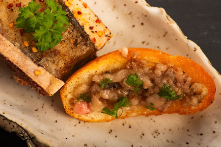 Roasted Bone Marrow with Spices and Baguette in Handmade Ceramic Bowl