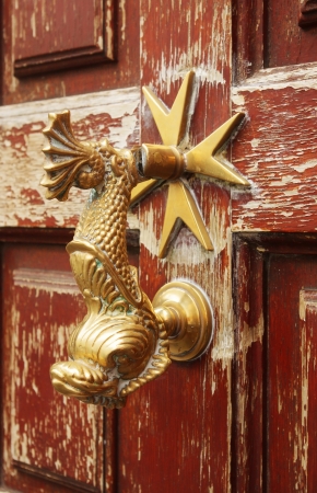 fish-shaped door knocker on a house in Riposto, Sicilyの写真素材