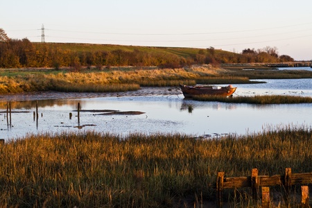 A small wooden fishing boat takes the morning off in Kent UK.のeditorial素材