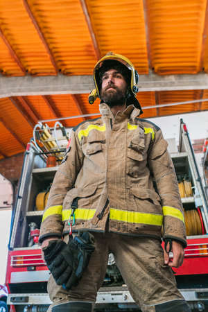 Recognizable firefighter man in fire truckの写真素材