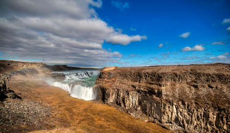 Emblematic stepped waterfall located at a pronounced elbow of the Hvita River.