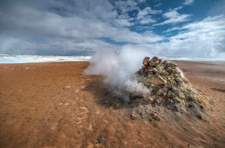 Geothermal area Namafjall Hverir, Iceland. The area around the boiling mud is multicolored and cracked.の写真素材