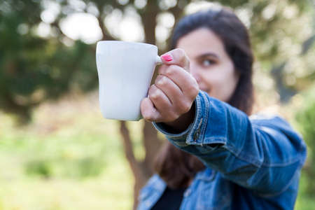 Woman holding a coffee mugの写真素材