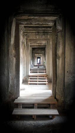 Endless tunnel in the temple of Angkor Wat. Walls made of stoneの写真素材