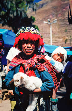 Beautiful portrait of a peruvian woman and her baby with traditional indigenous clothesのeditorial素材