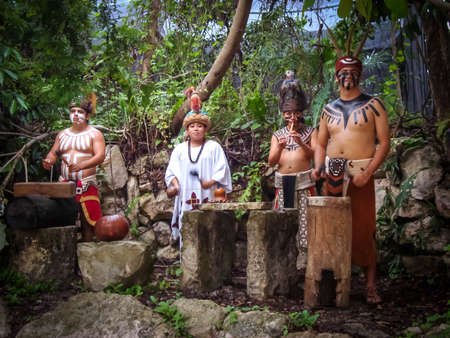 Mayan ceremony with maya people playing instruments and doing a ritual in Yucatan Mexico