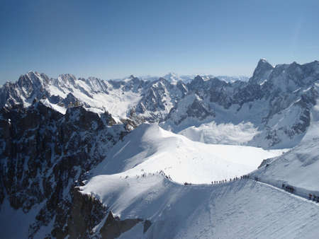 Line of skiers in the Valle Blanche, Chamonix, France. Very touristic place and sunny day, no cloudsの写真素材