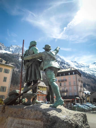 Sculpture in the main square of Chamonix of two mountaineers point to Mont Blanc in summer