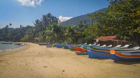 Amazing colored bots in the beach in Ilha Bela, Sao Paulo, Brazil. Summer day, beautiful beach , cool islandの写真素材