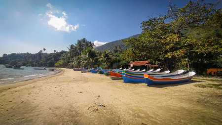 Amazing colored bots in the beach in Ilha Bela, Sao Paulo, Brazil. Summer day, beautiful beach , cool islandの写真素材