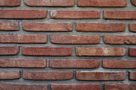 Red brick wall close up texture backgroundの写真素材