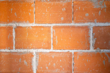 Brickwork background. House or site under construction. Building brick wall structure. Red brick wallの写真素材