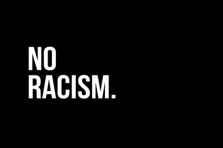 Racism. No more Racism. White text on red black background representing the need to stop racismの写真素材