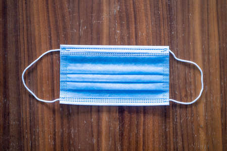 medical surgical face mask. mouth protection on dark wood background