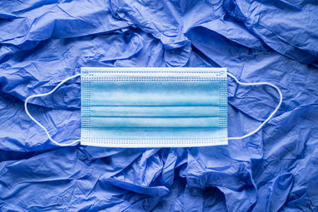 medical surgical face mask. mouth protection on disposable gloves background