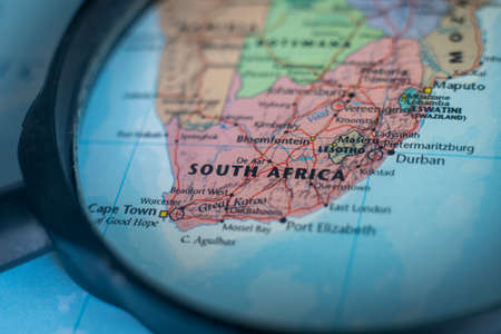 South Africa on a world map through magnifying glass. Republic of South Africa travel destination planning pinnedのeditorial素材