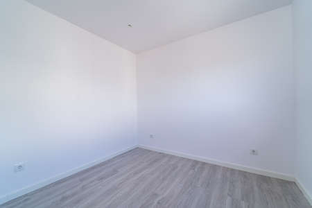 Empty room with gray wooden floating, laminate flooring. House interior, wide bedroom or living room space. New home, apartment or house. Wood floor. Real state and property managementの写真素材