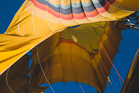 Colorful balloons flying over mountains and with blue skyの写真素材