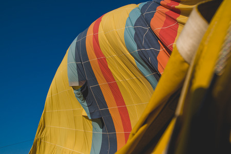 Colorful balloons flying over mountains and with blue skyの写真素材