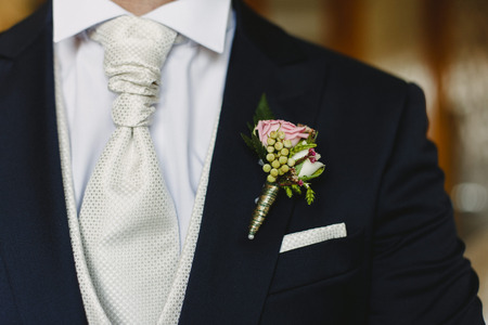 Groom dressing to go to his weddingの写真素材
