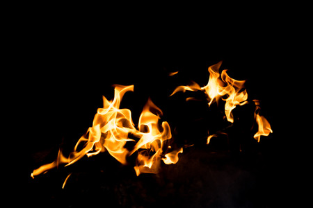 Flames in the fire of a red and yellow barbecue.の写真素材