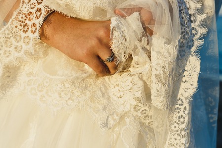 Bride preparing for her wedding, putting on the garter and lingerieの写真素材