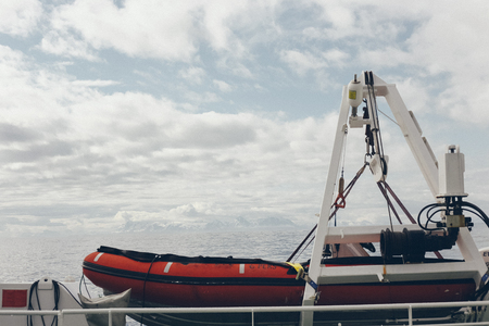 Lifeboat with snowy mountains in the backgroundの写真素材